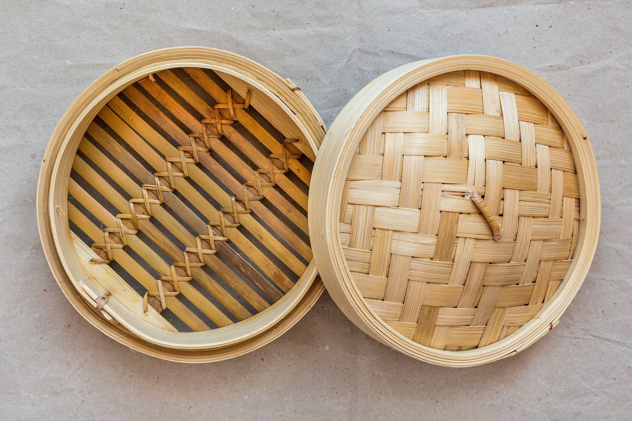 竹製の蒸し器セット、灰色の紙に中華台所用品。