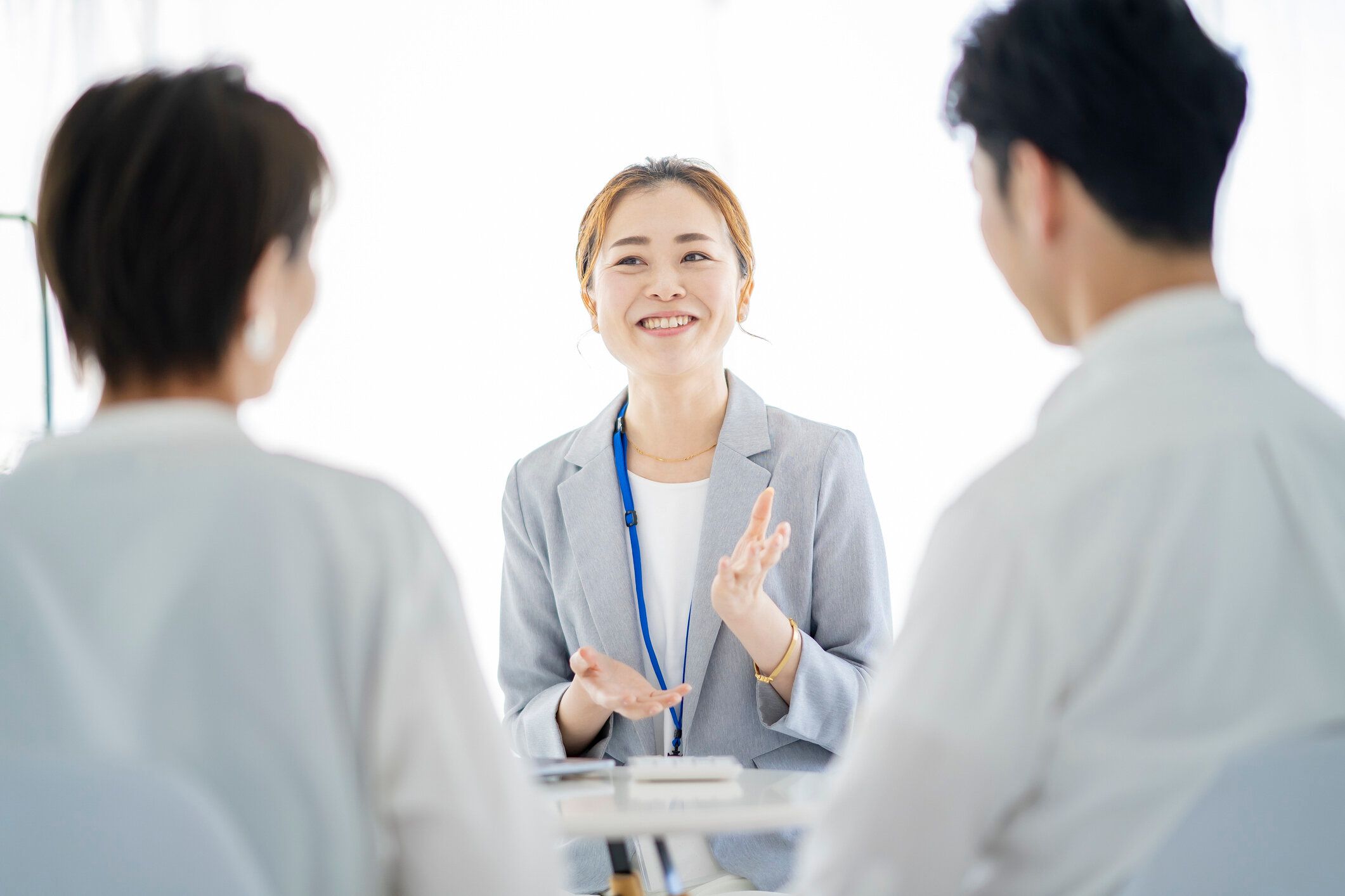 カップルに説明するスーツを着た女性