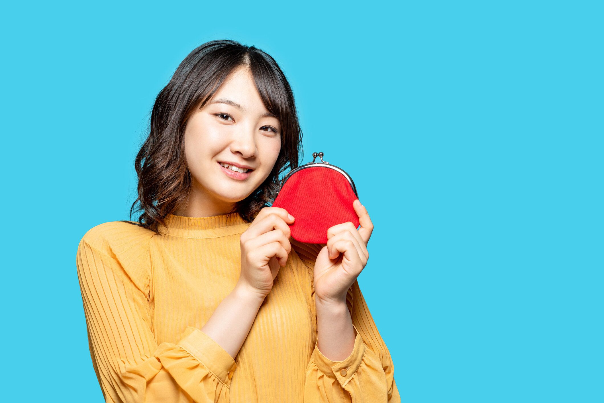 財布を持っている若いアジアの女の子。