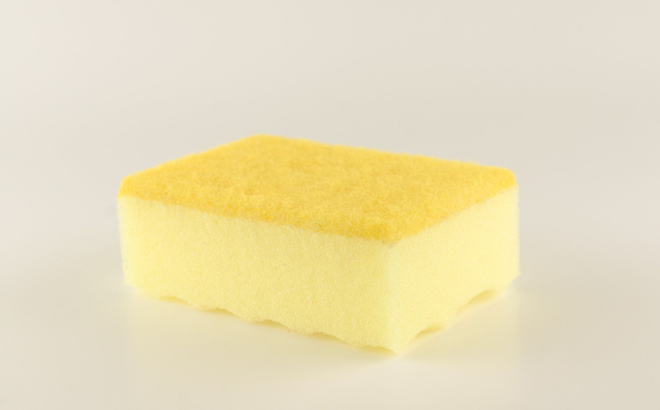 洗濯皿のための白い背景に隔離された泡ゴムスポンジ