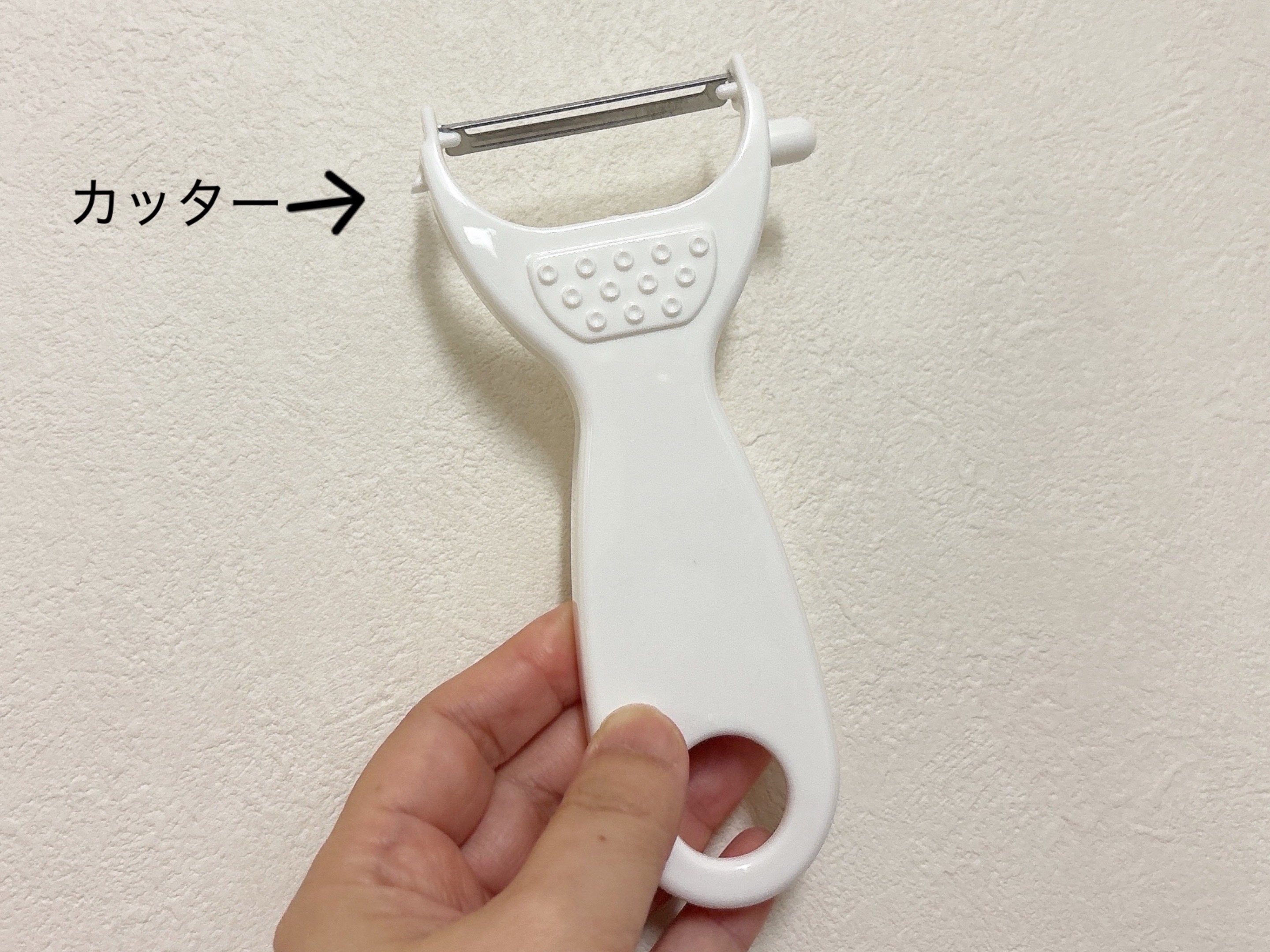 ダイソー多機能ピーラーを手に持っている画像