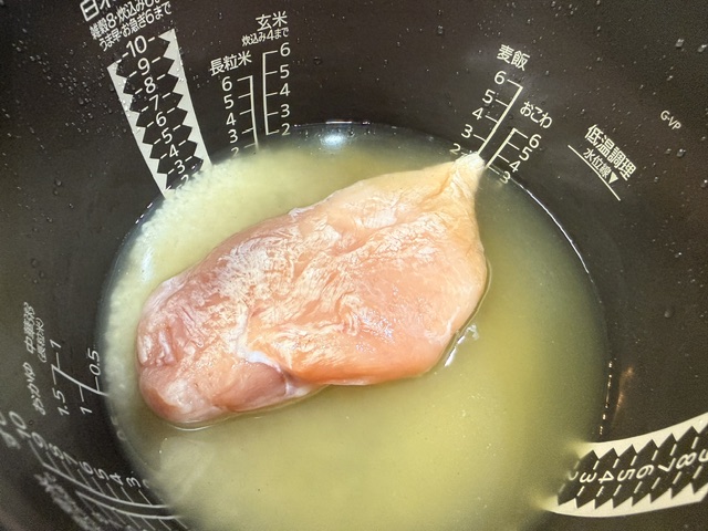 鶏肉を炊飯器に加える様子